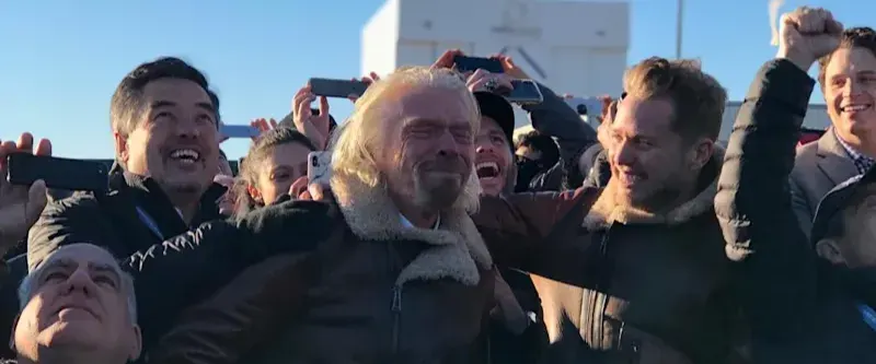 Richard Branson getting tearful, surrounded and cheered on by Sam Branson and others