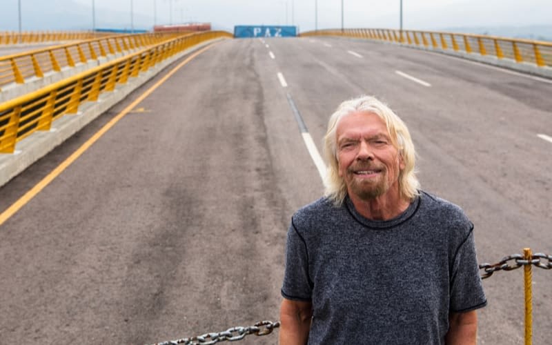 Richard Branson standing on the blocked bridge between Colombia and Venezuela 