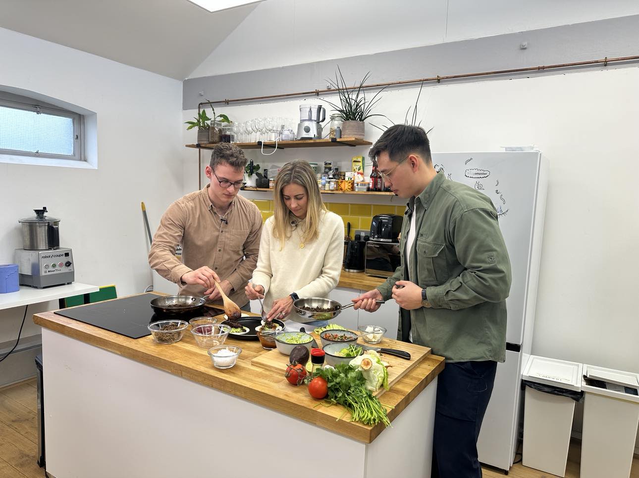 Holly Branson cooking tacos with the founders of Yum Bug