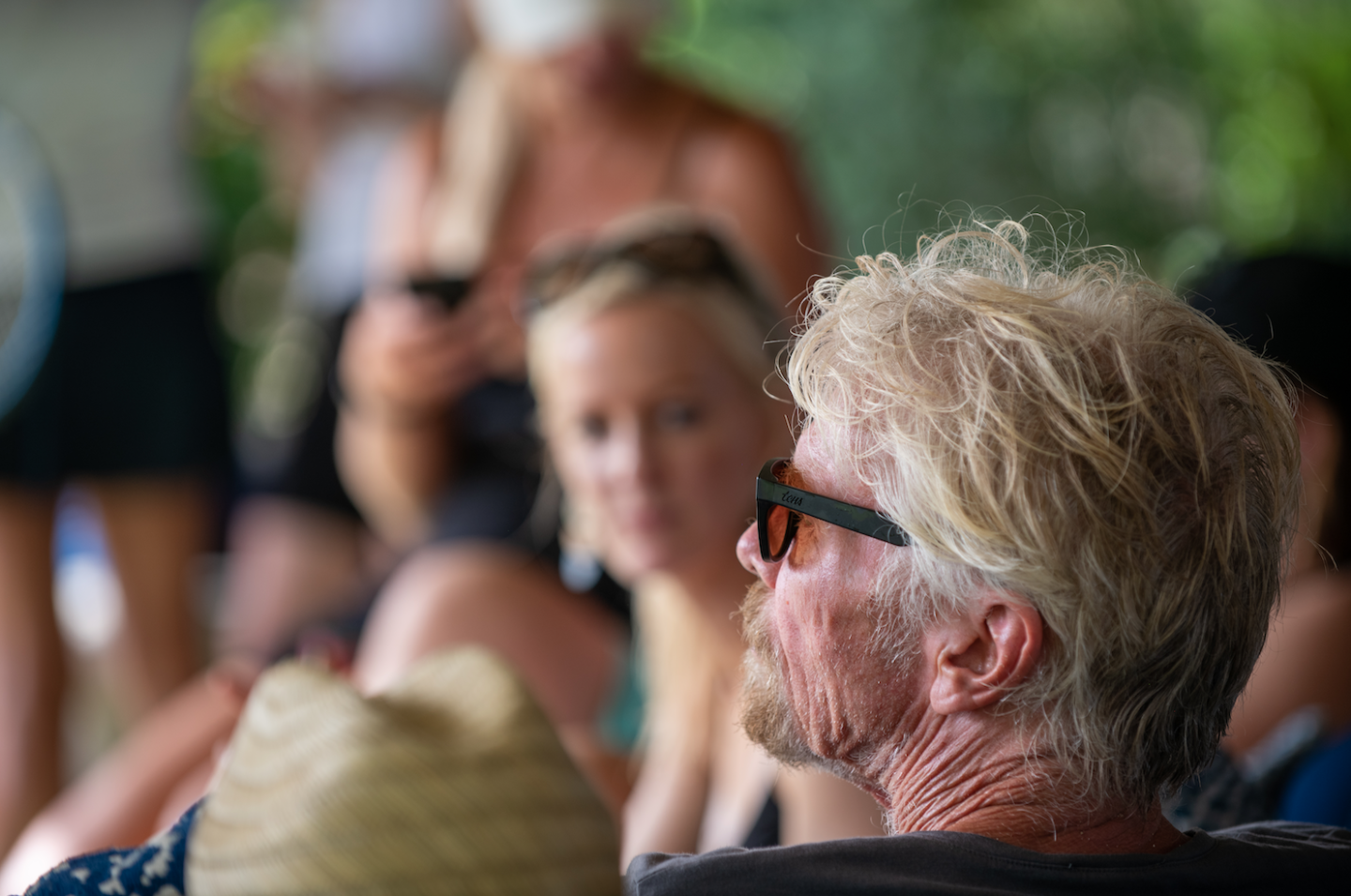 Richard Branson listening to a speaker at a Virgin Unite event on Necker Island