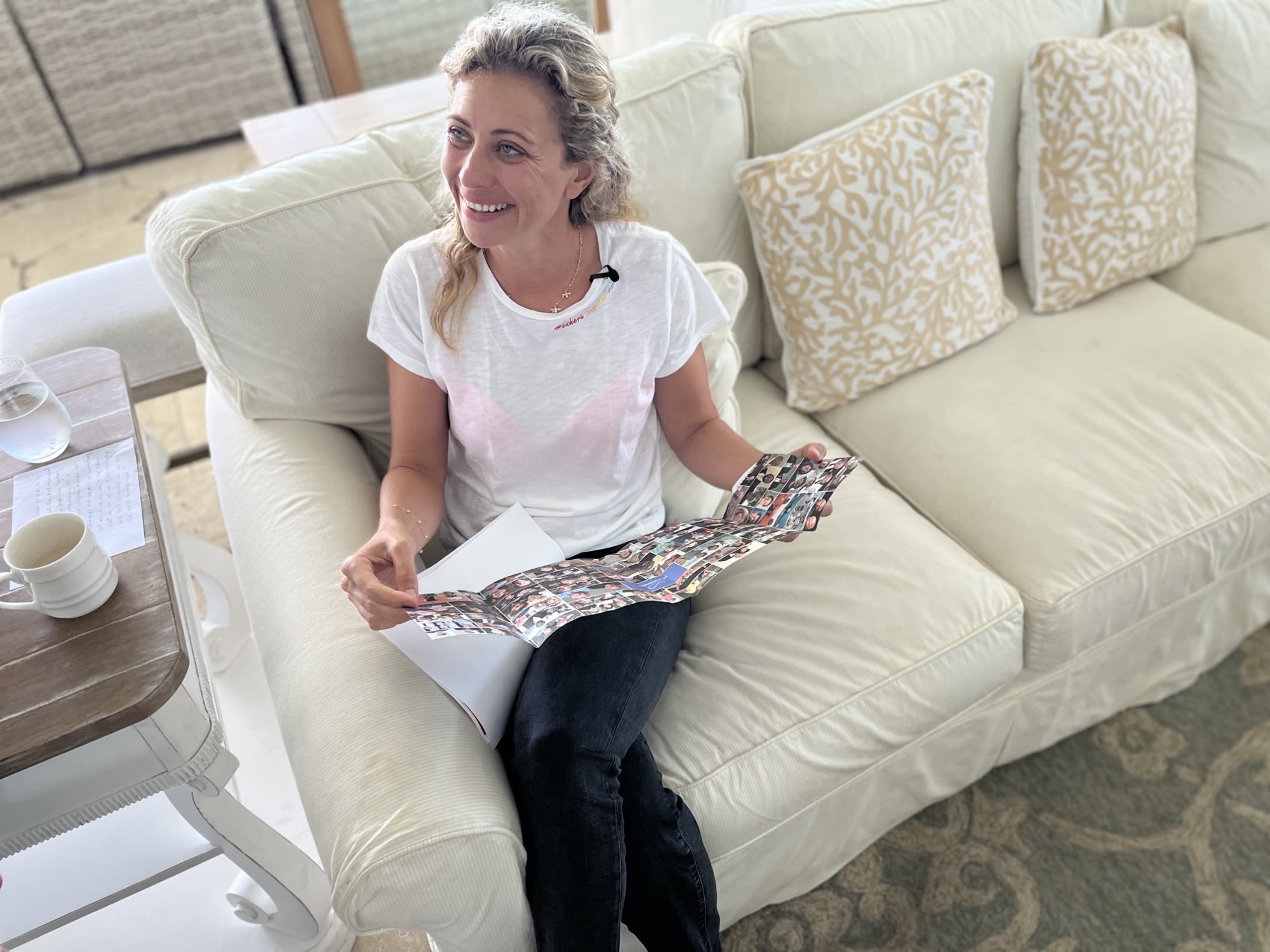 Holly Branson smiling on the sofa with Jean Oelwang's new book - Partnering