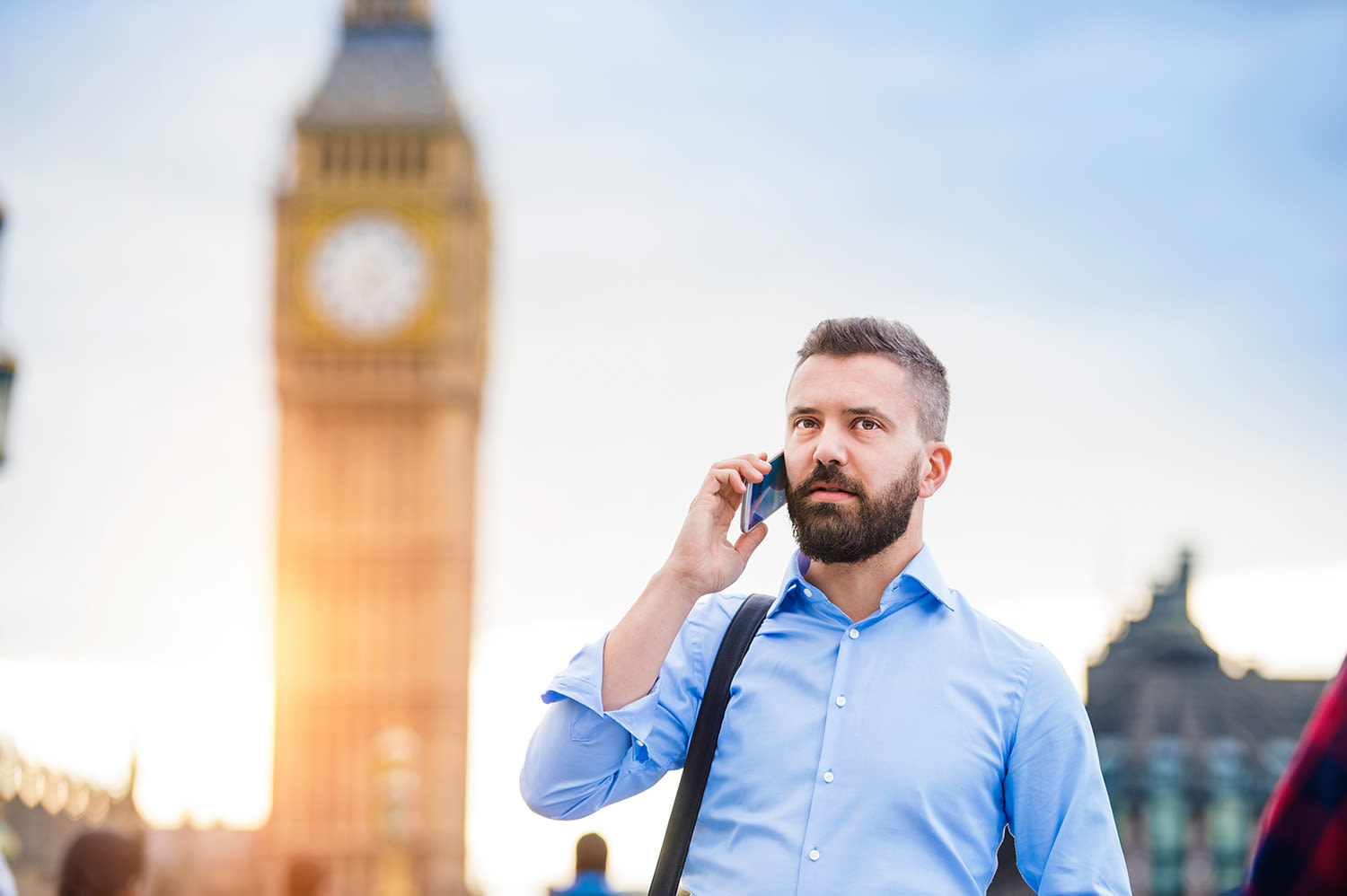 A man talking on a mobile phone in front of Big Ben
