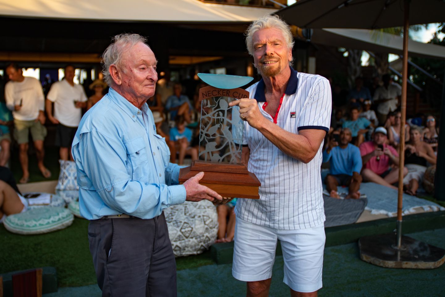 A man and Richard Branson posing with a trophy