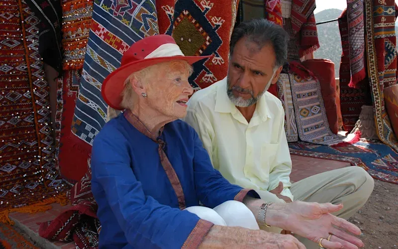 Eve Branson in Morocco, sitting next to a man, talking