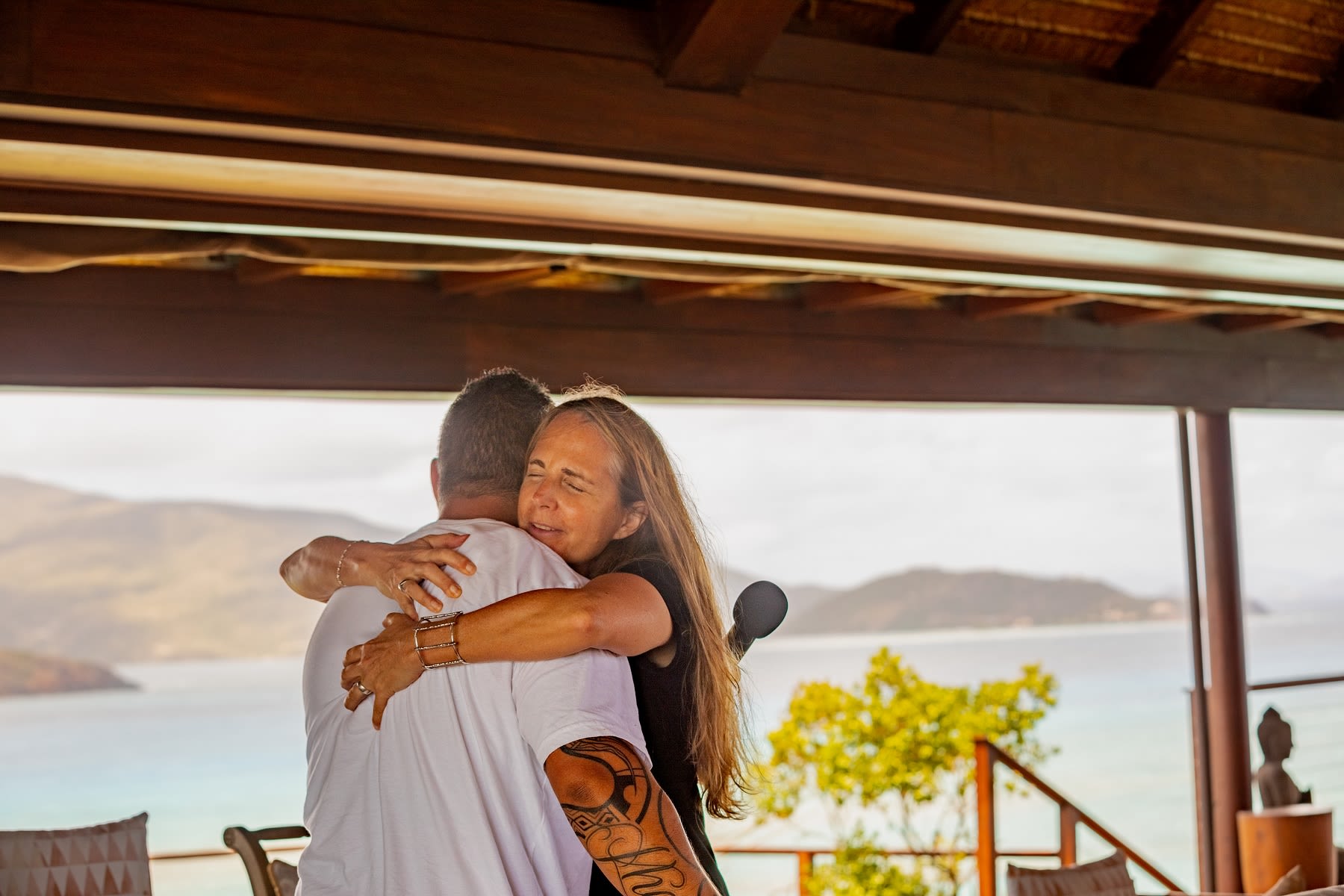 Jean Oelwang with Keenan Mundine hugging at a Virgin Unite Necker Gathering