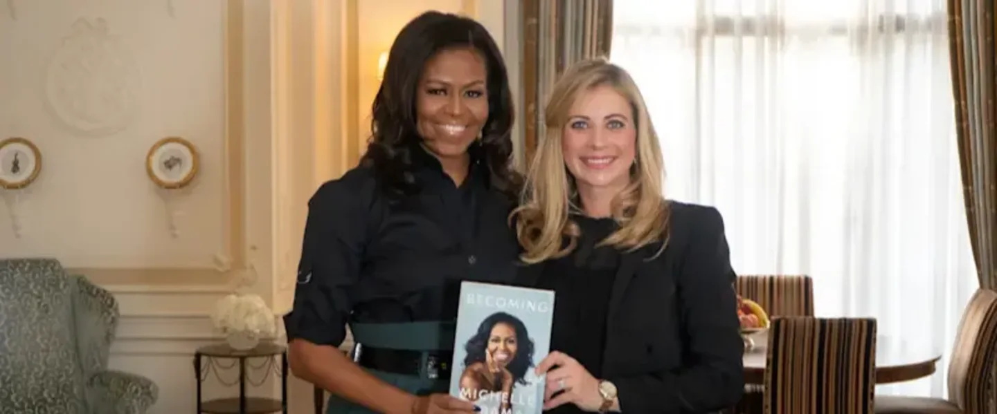 Holly Branson with Michelle Obama holding a copy of Becoming