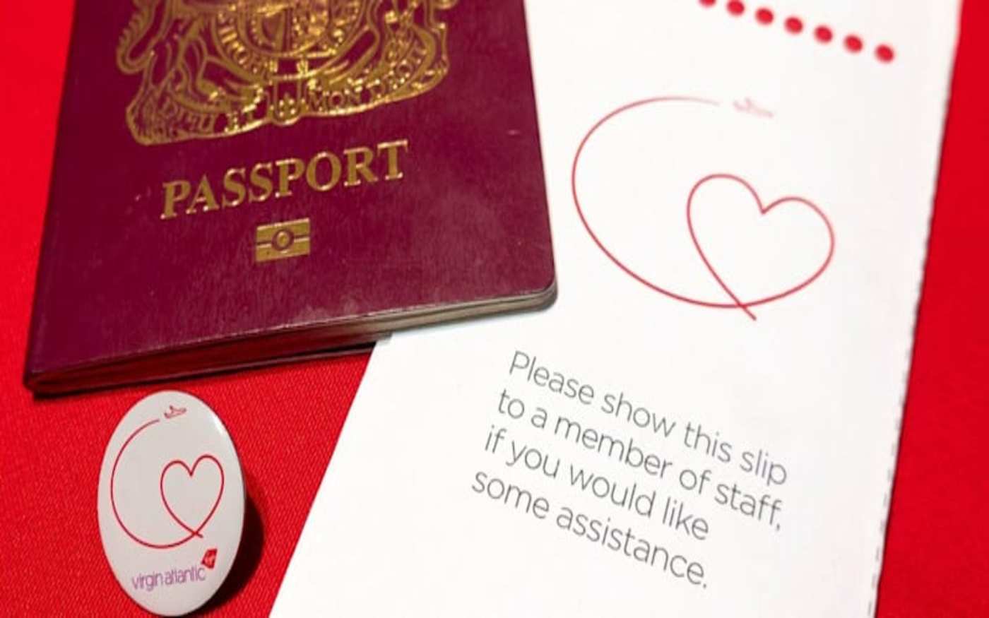 A UK passport with a badge and slip passengers show Virgin Atlantic cabin crew if they require assistance