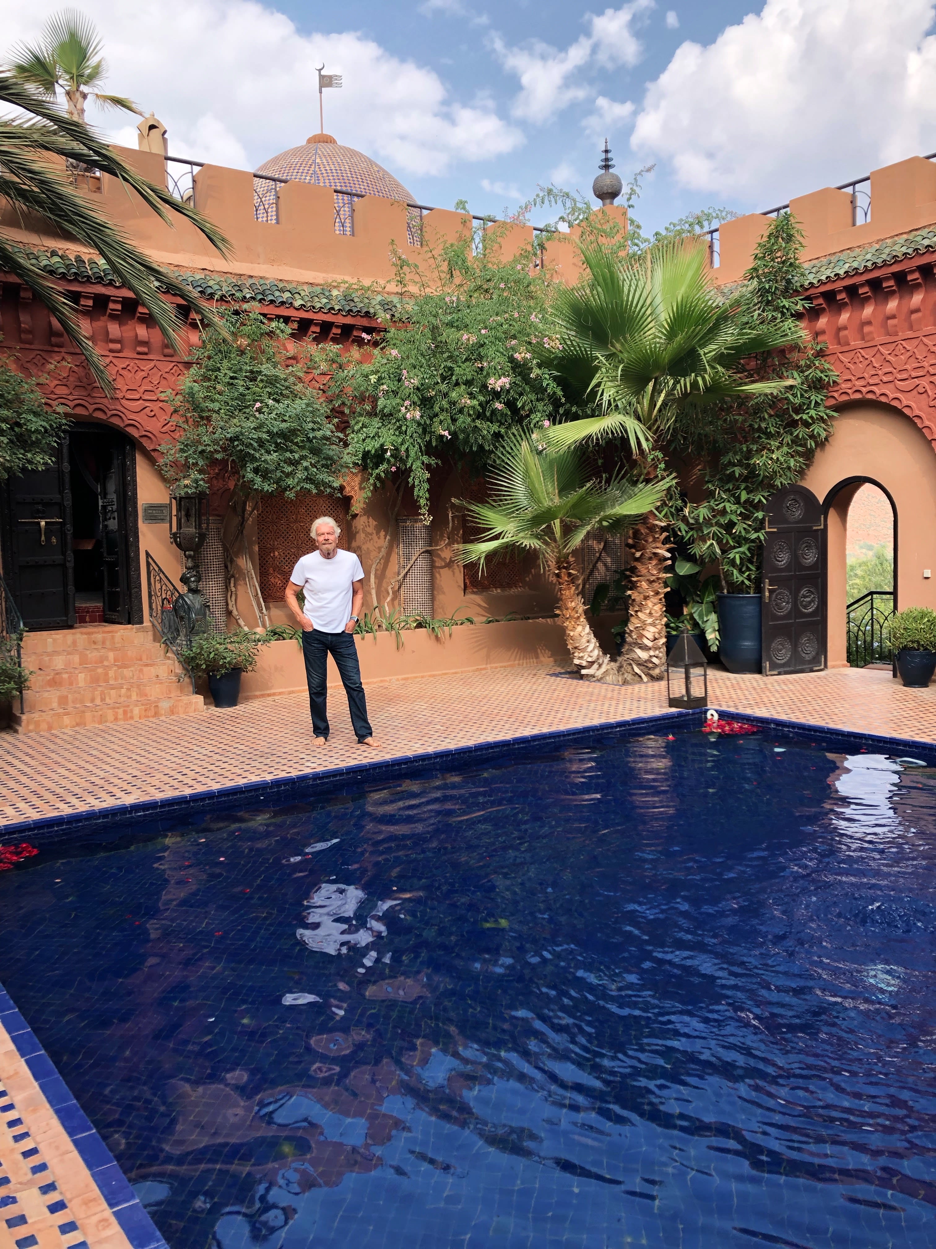 Richard Branson smiles from across a courtyard at Kasbah Tamadot in Morocco