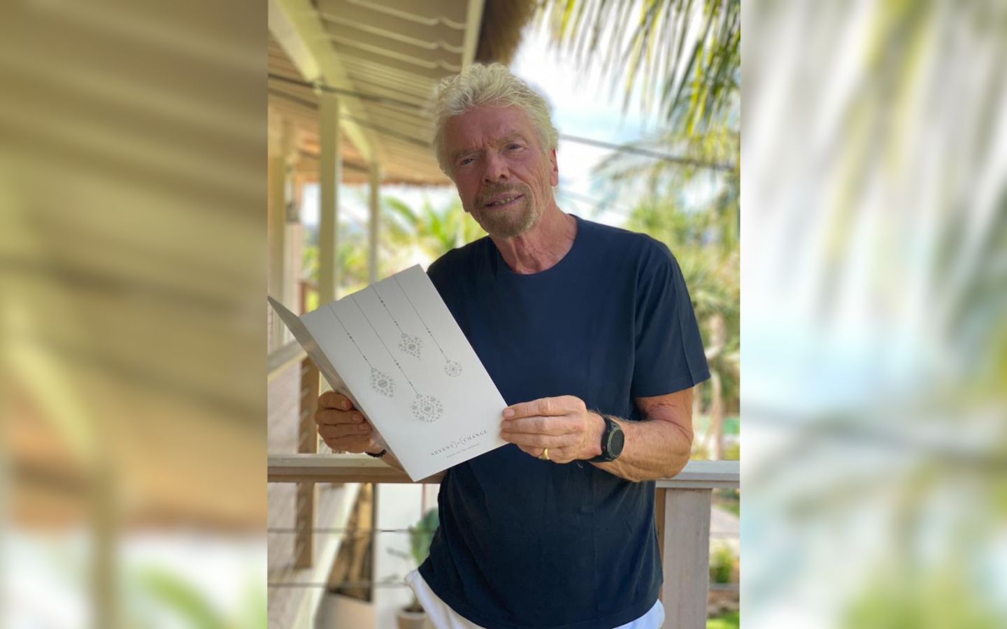 Richard Branson holding an Advent of Change calendar 