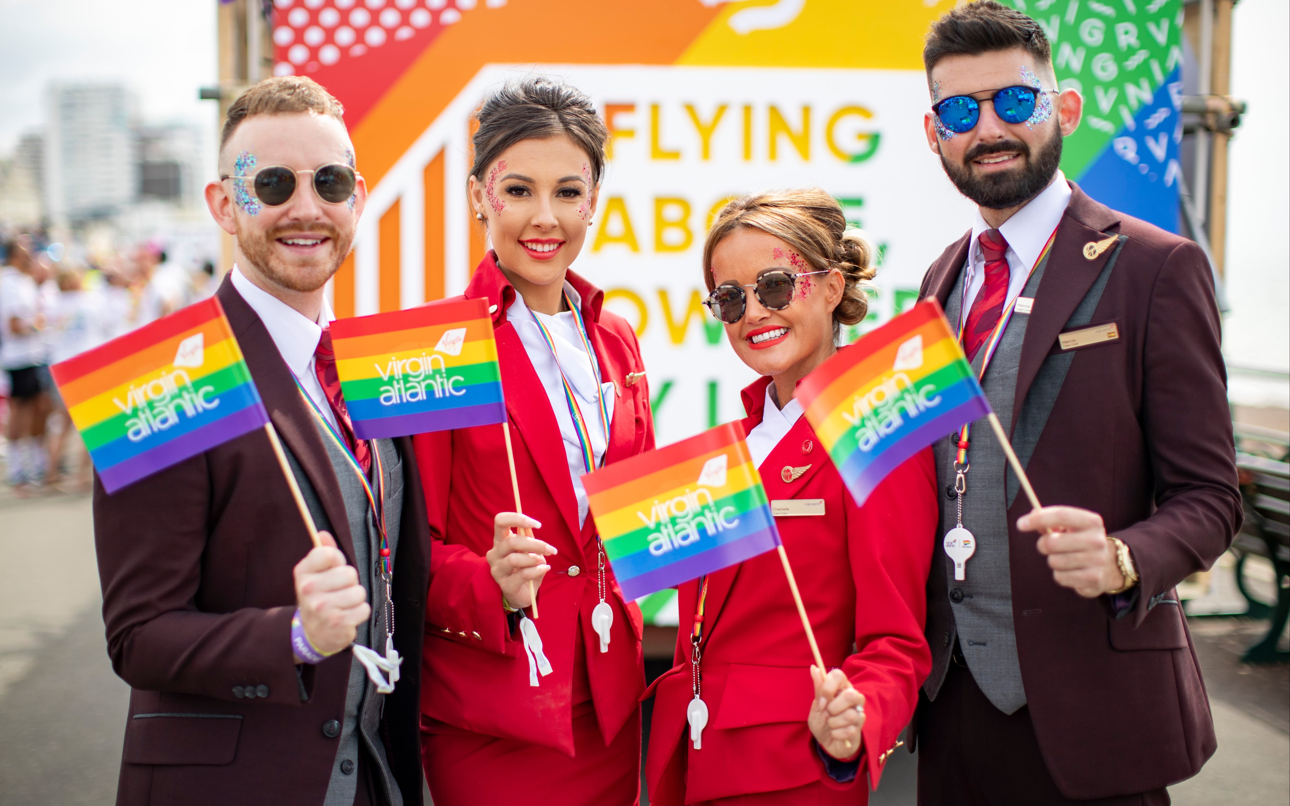 Virgin Atlantic employees hold Virgin Atlantic pride flags