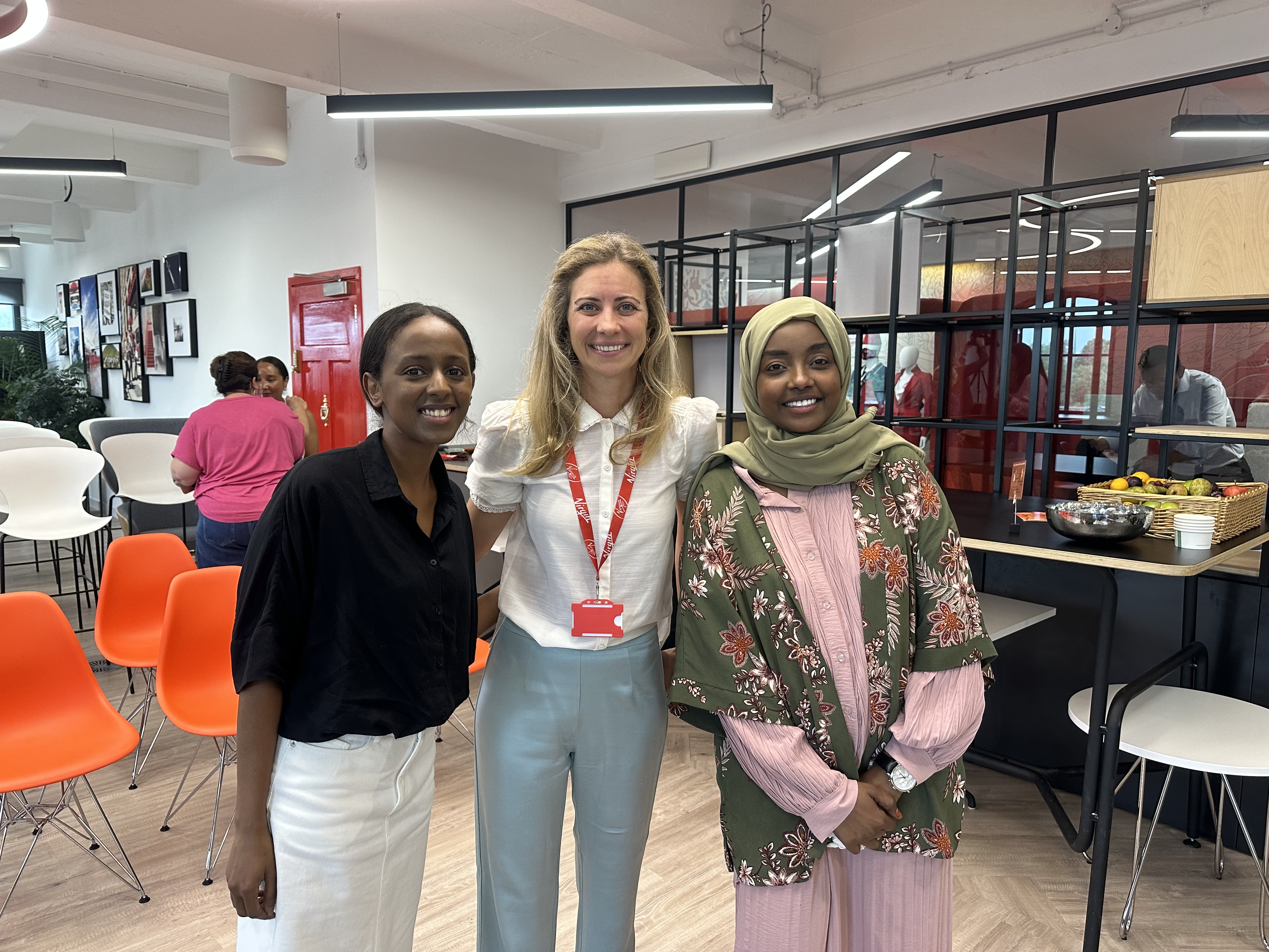 Holly Branson smiling with Nawal and Mariam on World Refugee Day