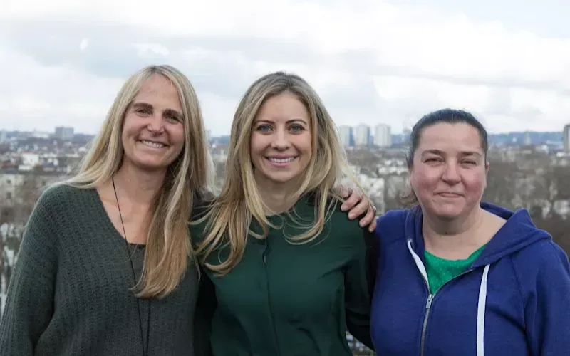 Holly Branson and two ladies posing with a city background