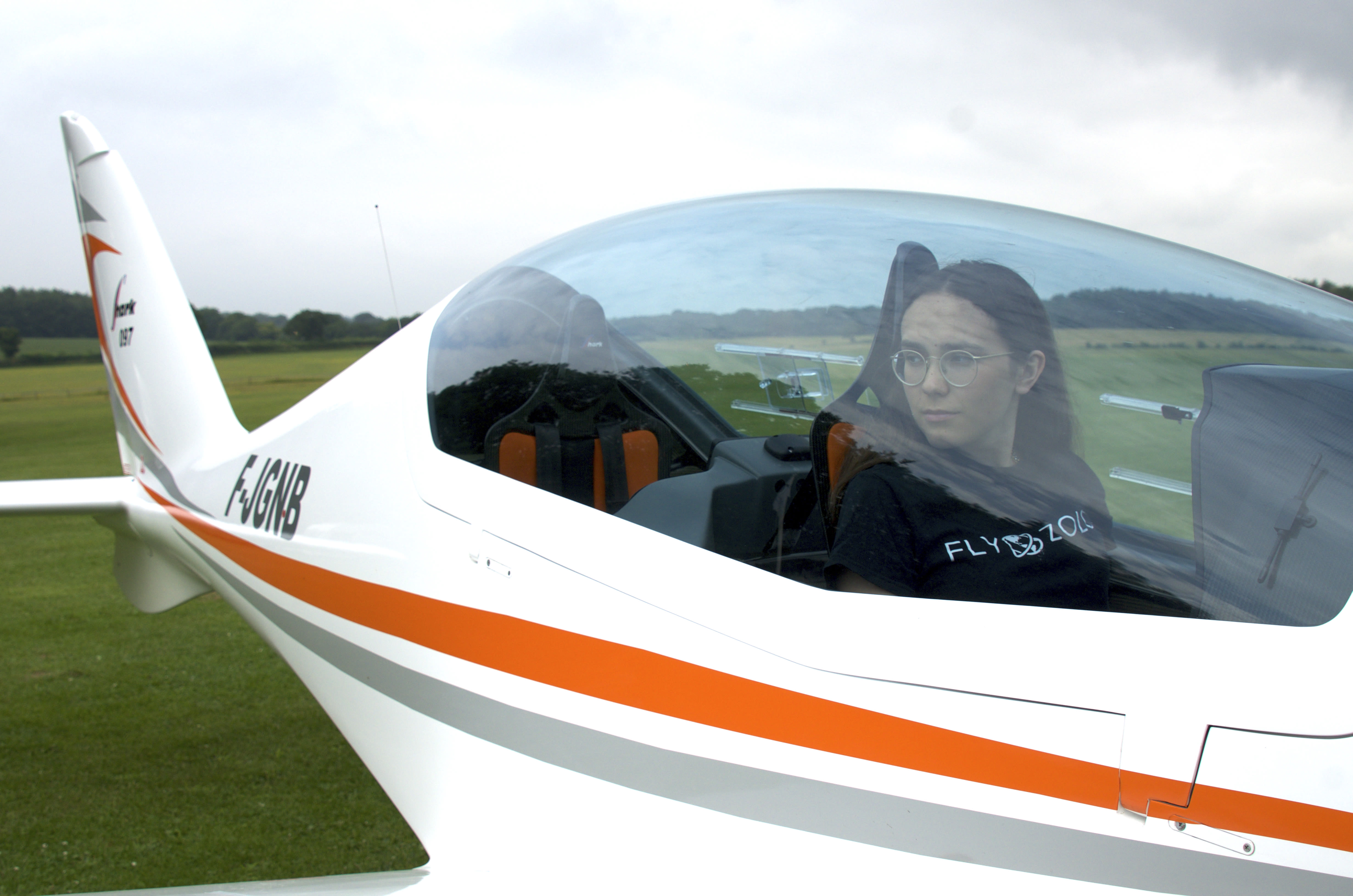 Zara Rutherford looks outside the window of her shark plane