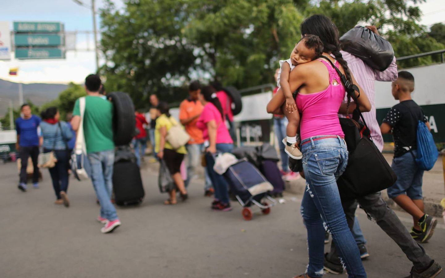 Venezuelan refugees walking with suitcases