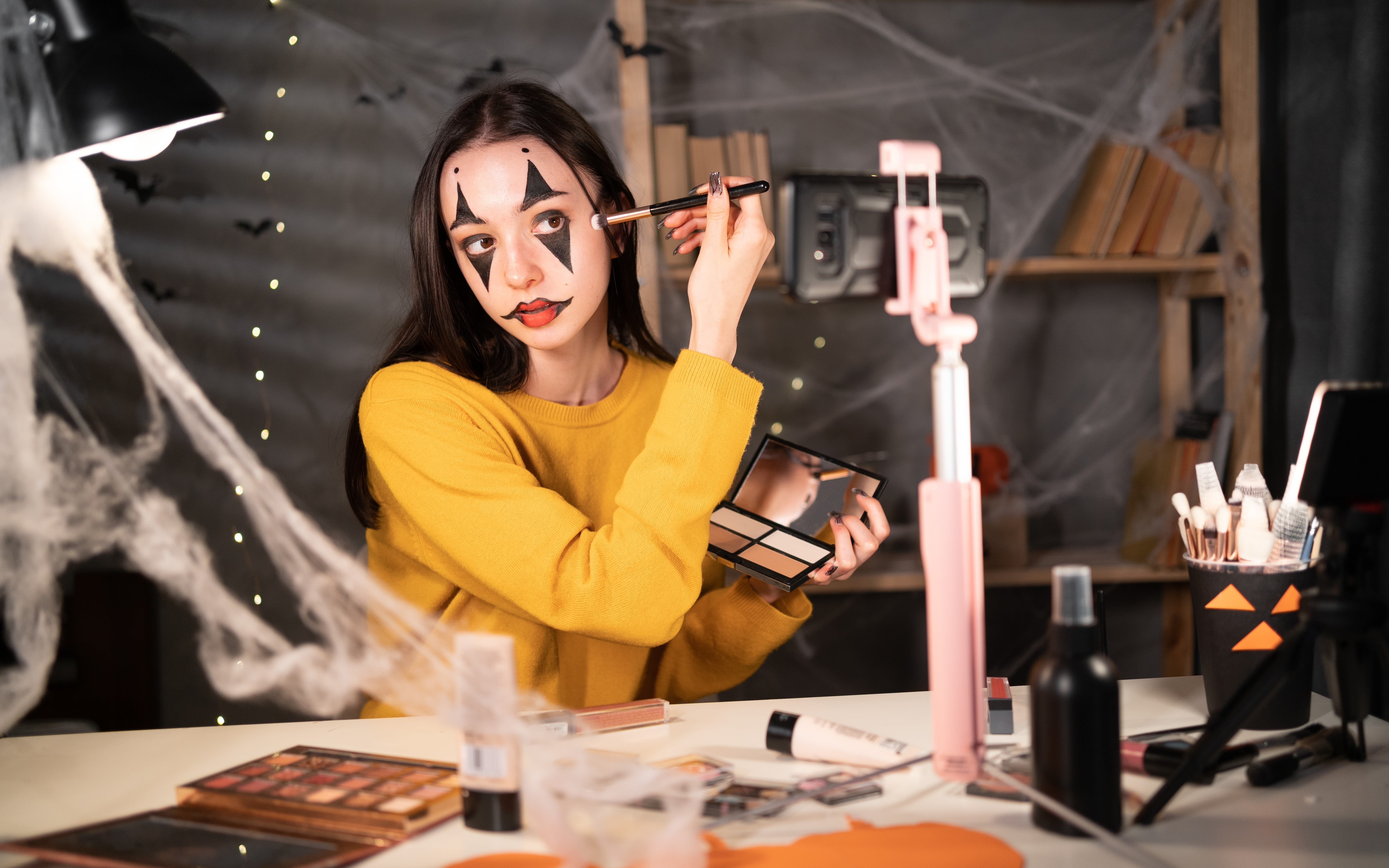 Woman applies Halloween make-up