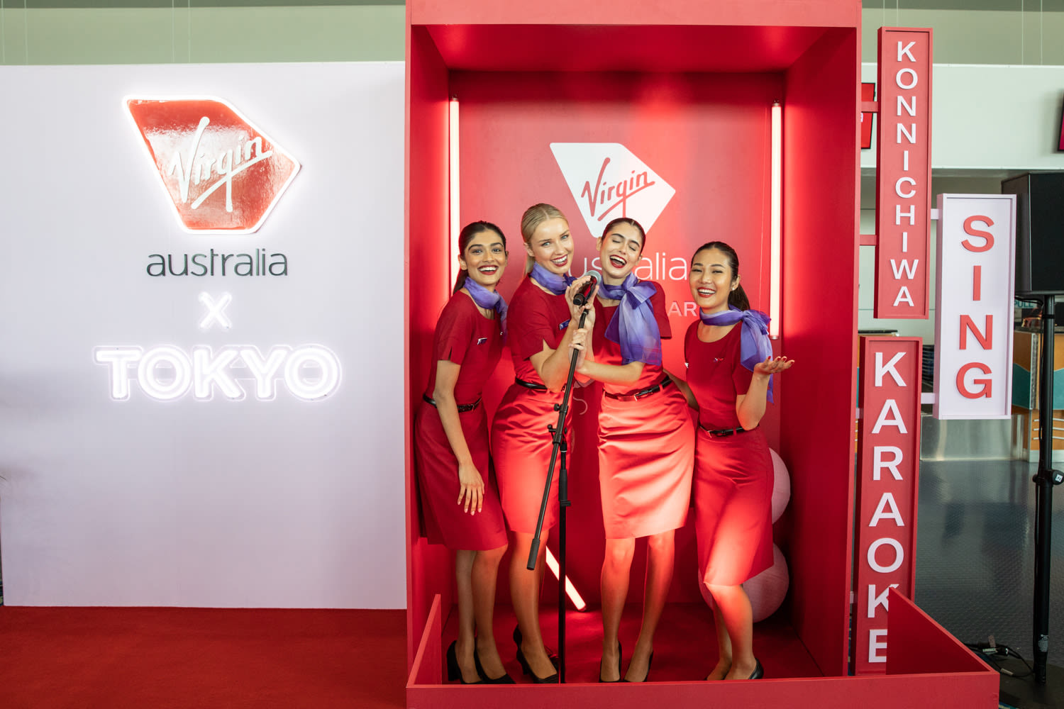 Virgin Australia cabin crew in a karaoke booth at Cairns Airport to celebrate the new Tokyo route