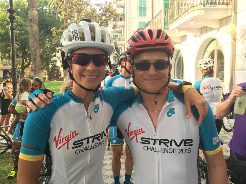 Holly Branson and Paul Williams smile for a picture while cycling on the 2016 Strive Challenge