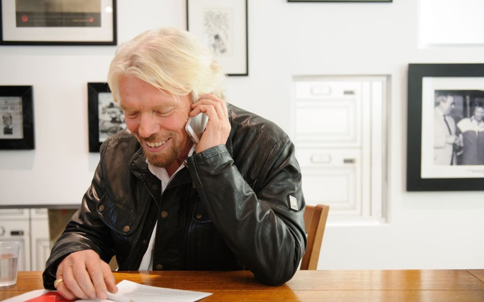 Richard Branson speaking on a mobile phone in the office 