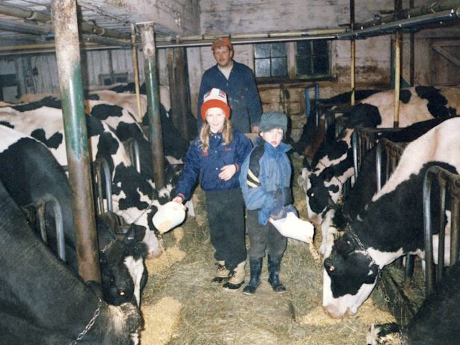 I was born and raise on a dairy farm in rural Minnesota. At milking-time, my sister and I helped out as much as we could. Here we are feeding grain to some happy milk cows while my dad watched from the background. We had about 50 head and they were all friendly.