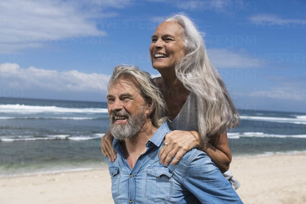 handsome-senior-couple-having-fun-at-the-beach-SBOF01079