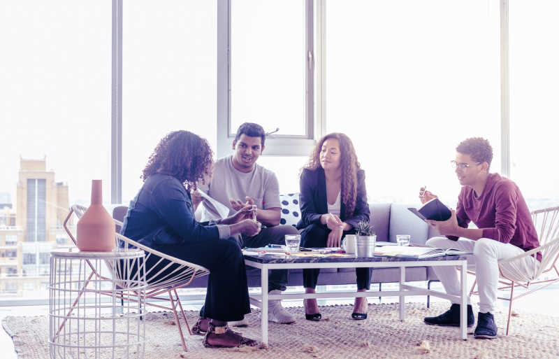 Illustration of two men and two women talking in an office