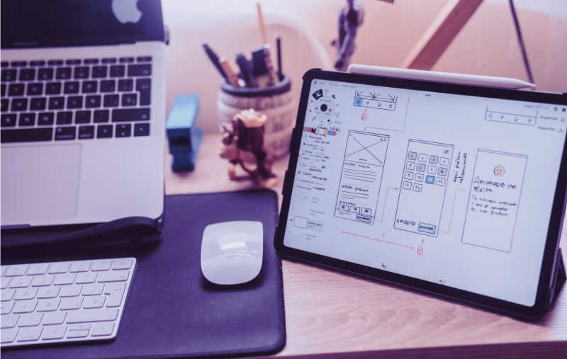 Illustration of tablet, laptop, keyboard and mouse on a table