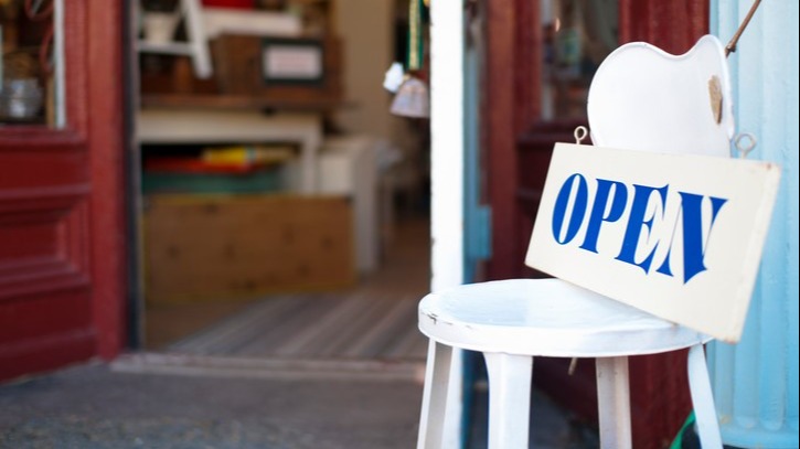 An open sign leading to a charity shop