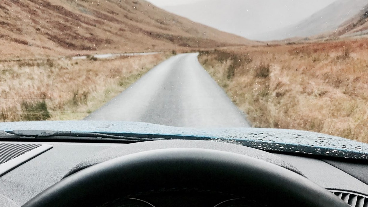 View from car windscreen of country road 