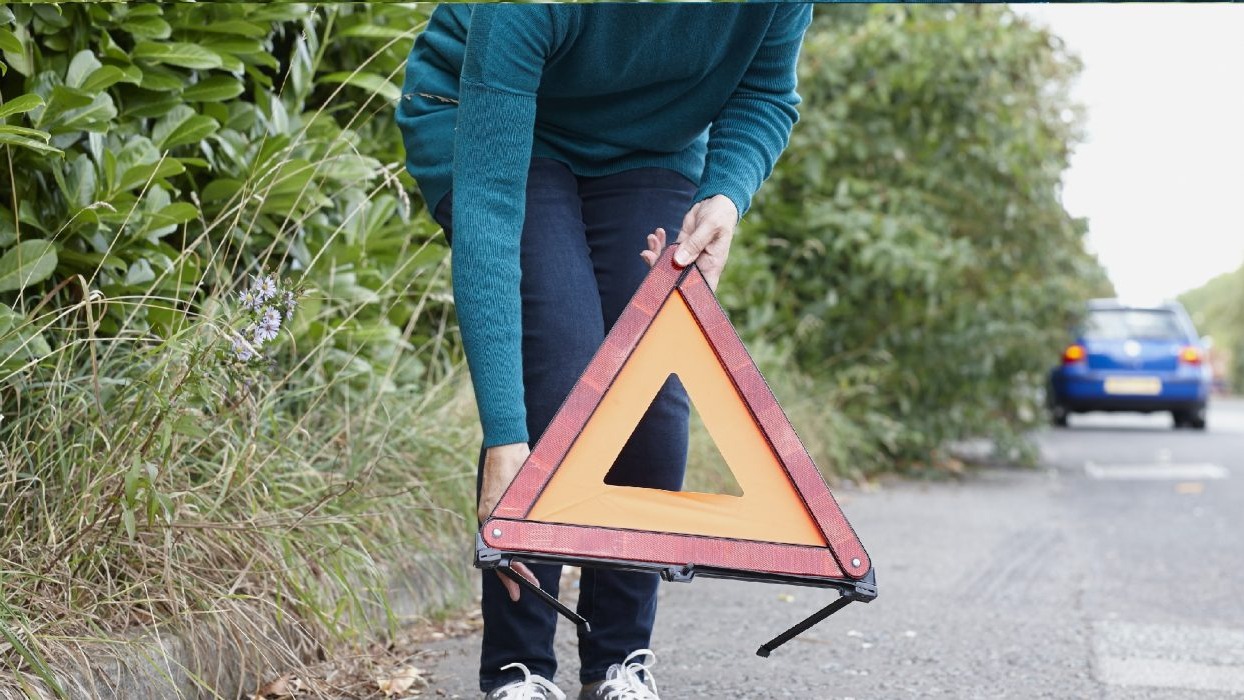 Person placing warning sign on the ground