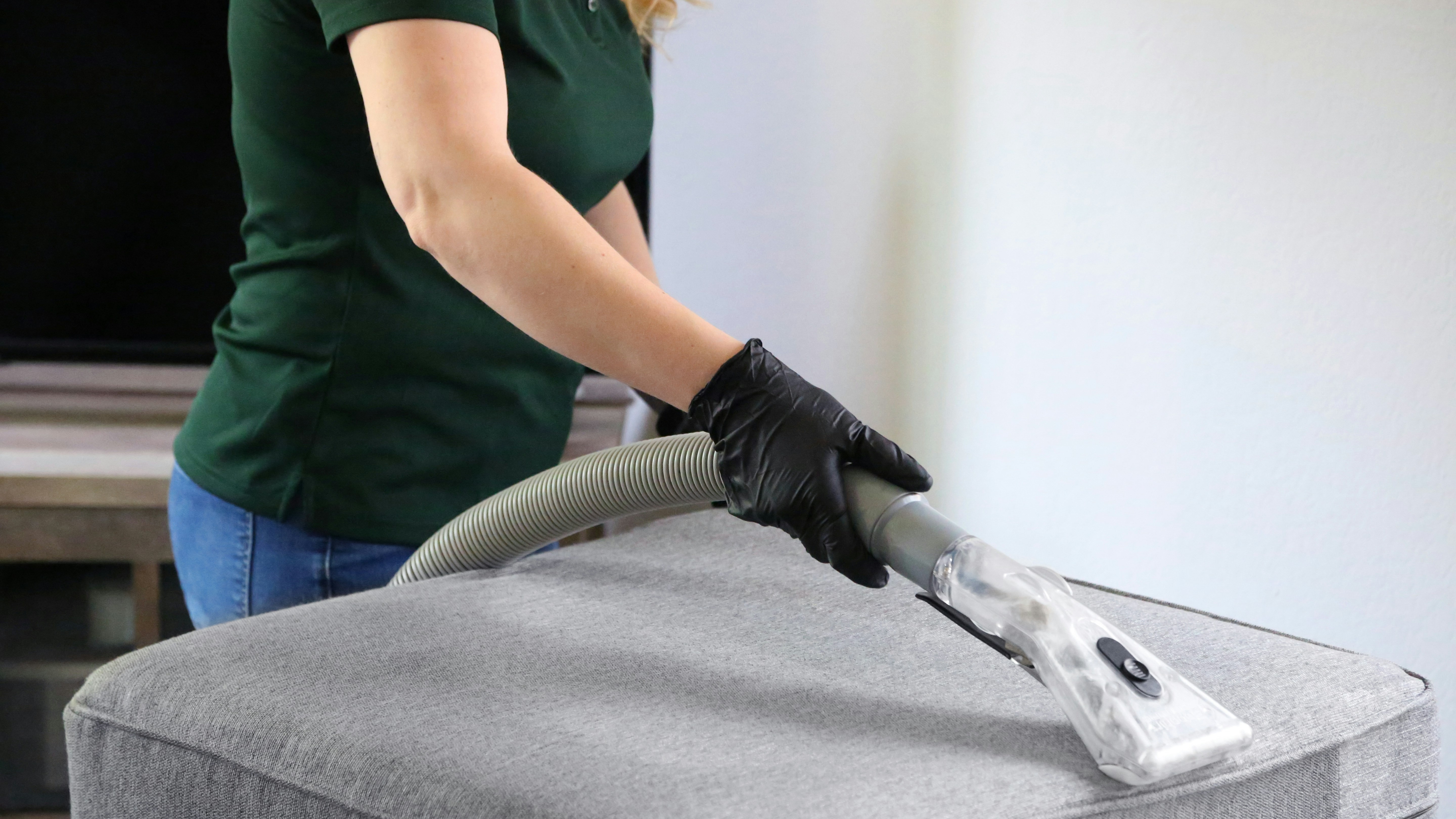 Person hoovering sofa