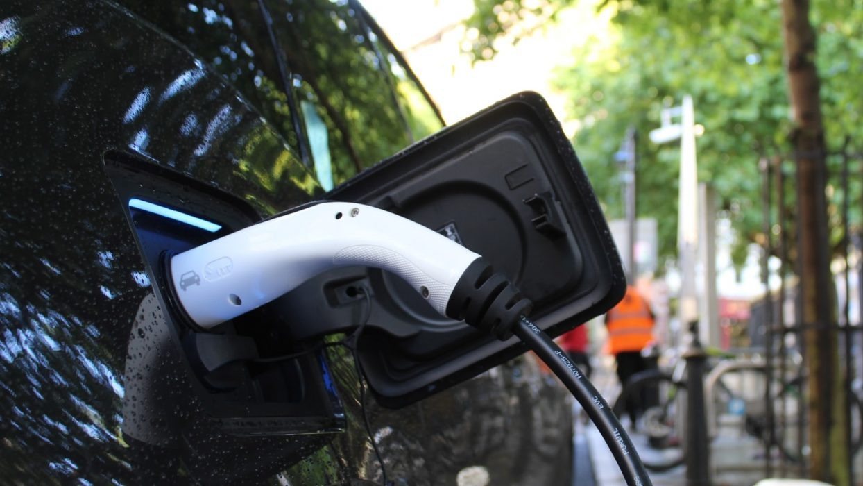 Electric car charger plugged into car