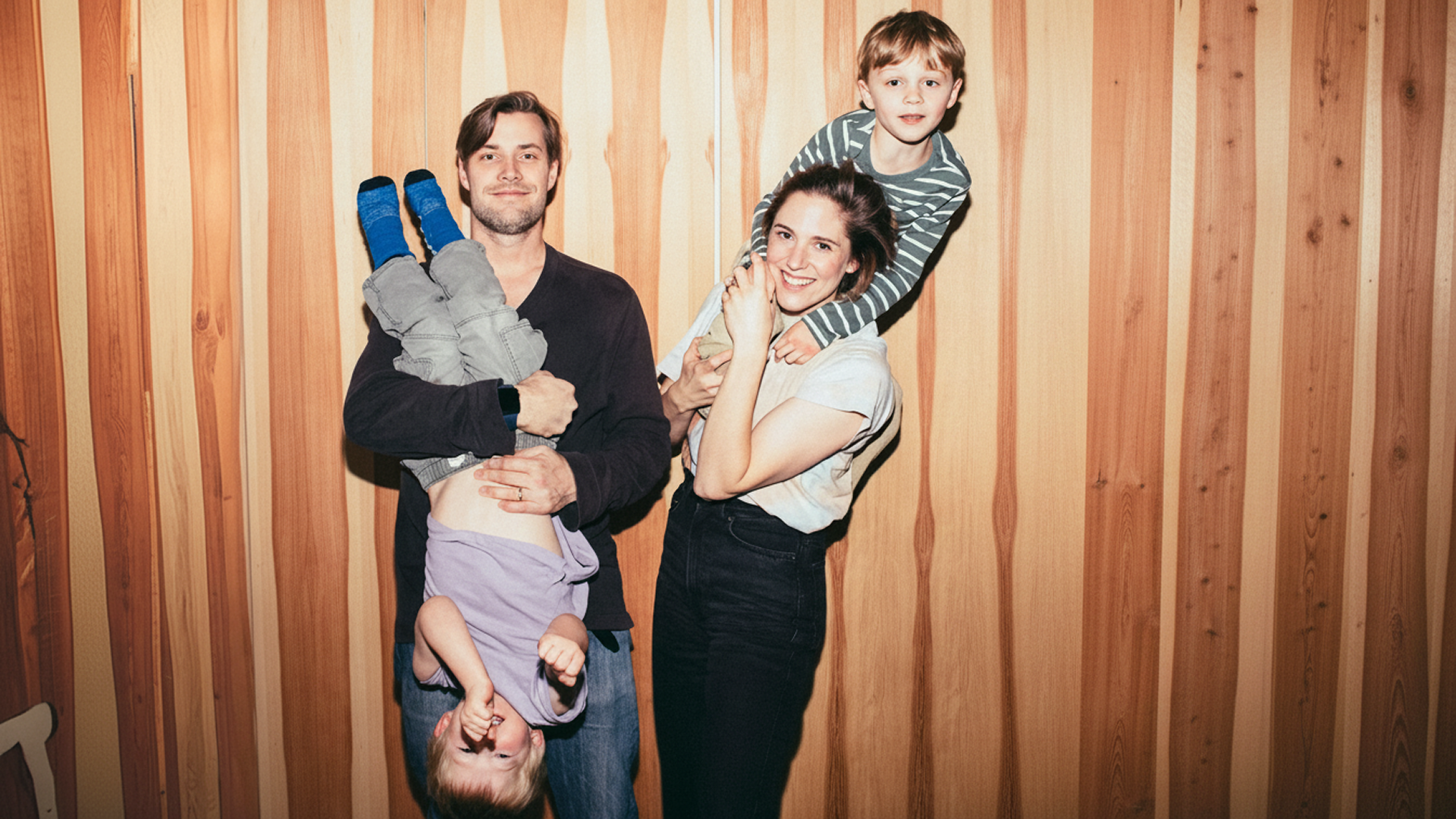 Two parents holding their two children
