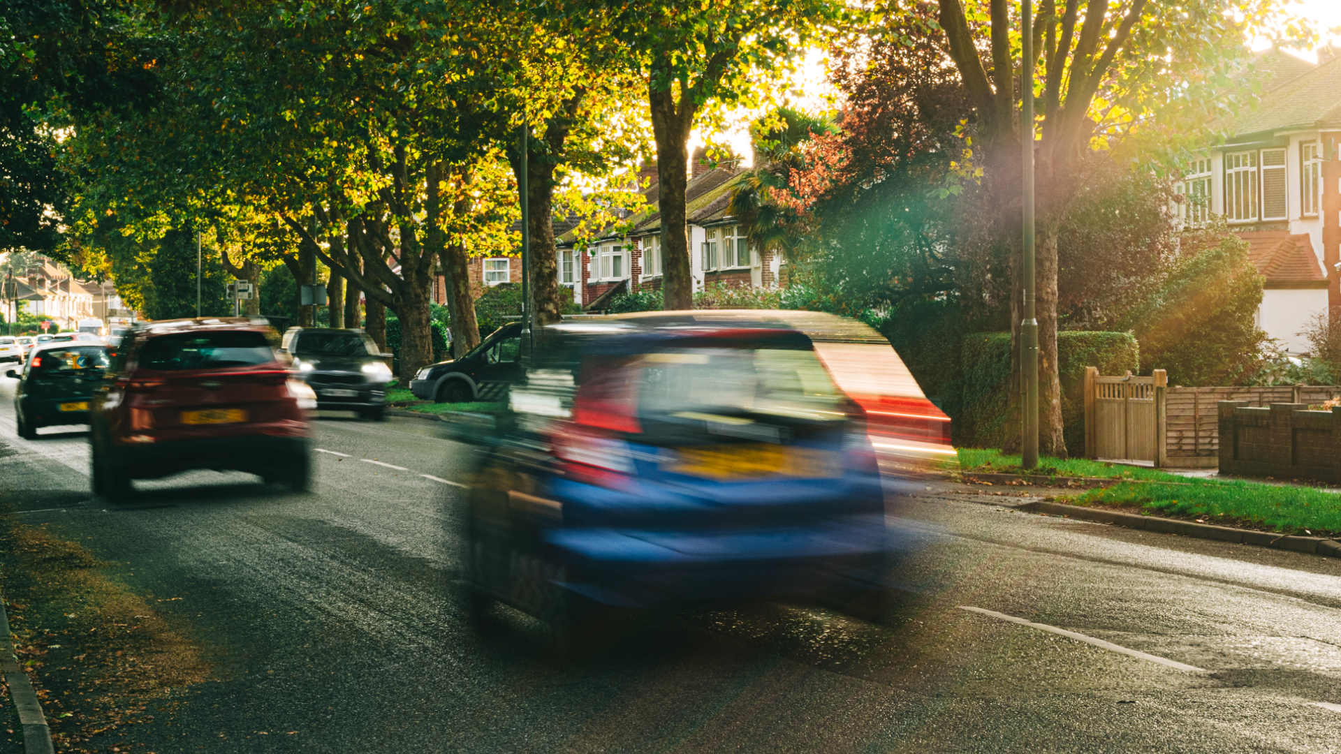 Car driving at fast speed down street
