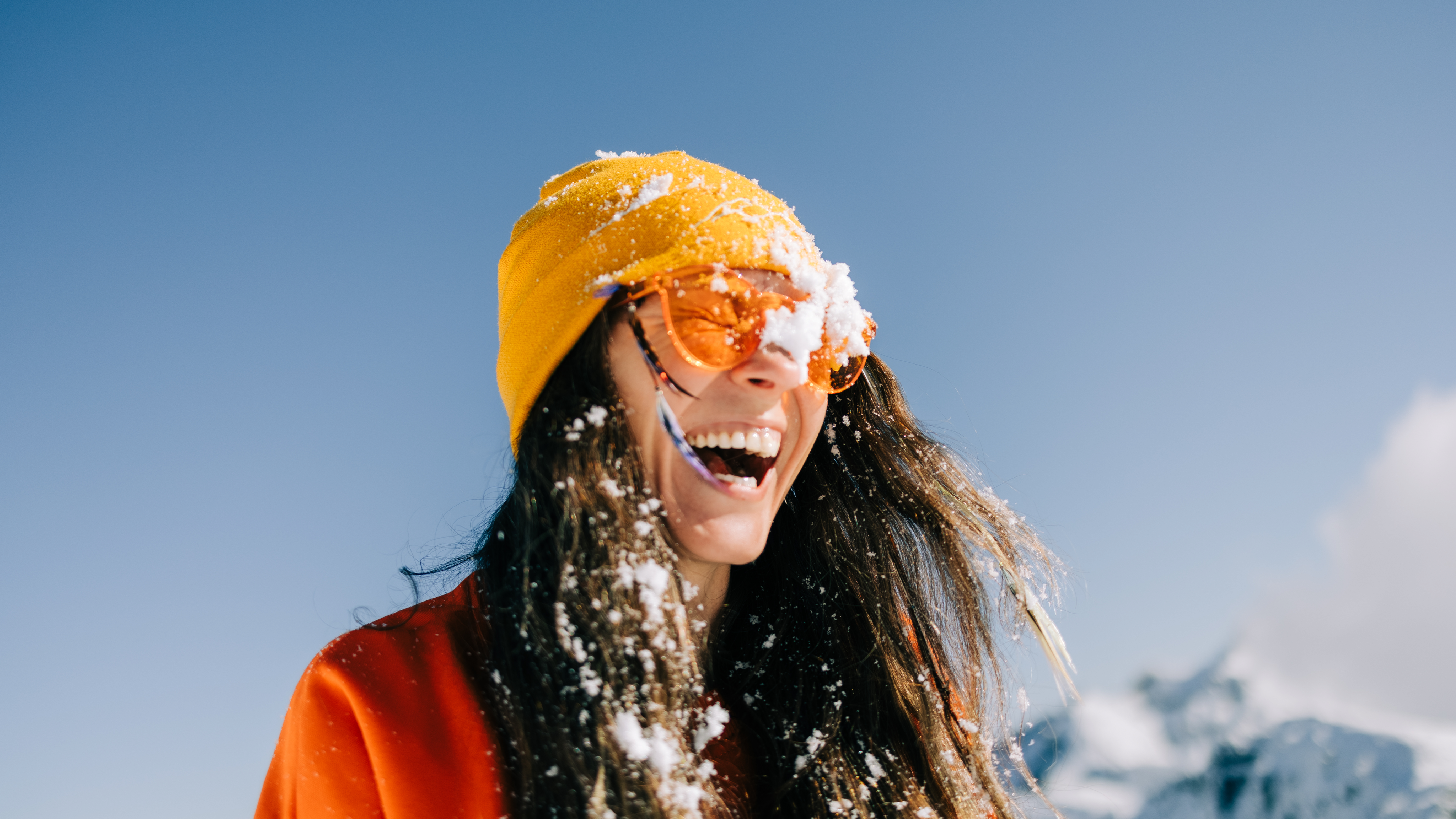 Woman laughing with snow on her face