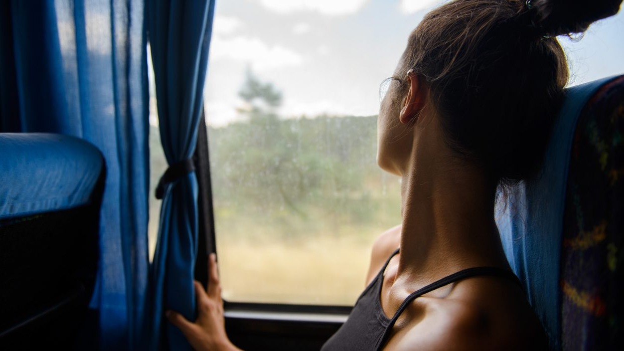Person sat on a bus looking out of the window
