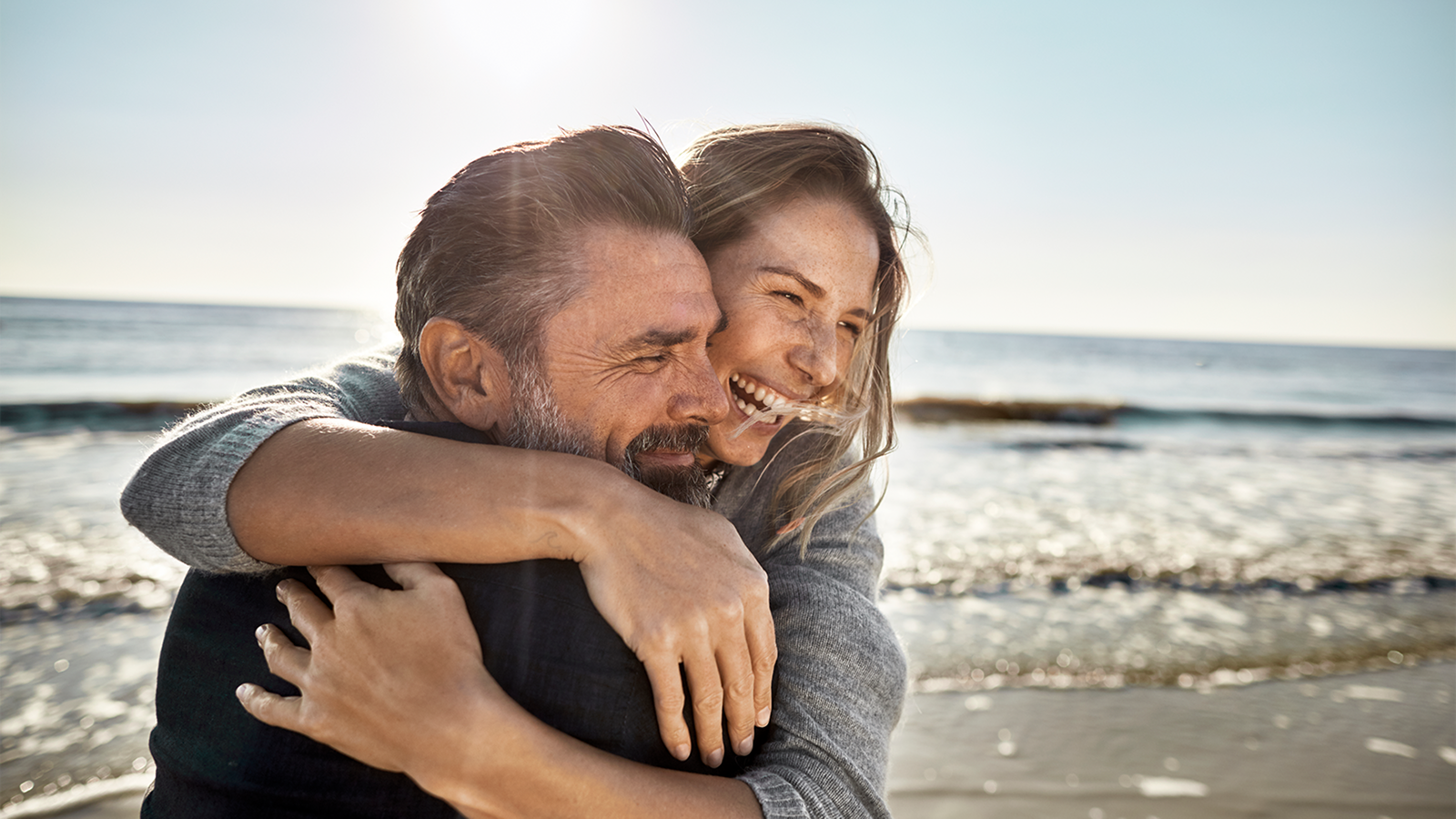 Man and woman hugging on a beach