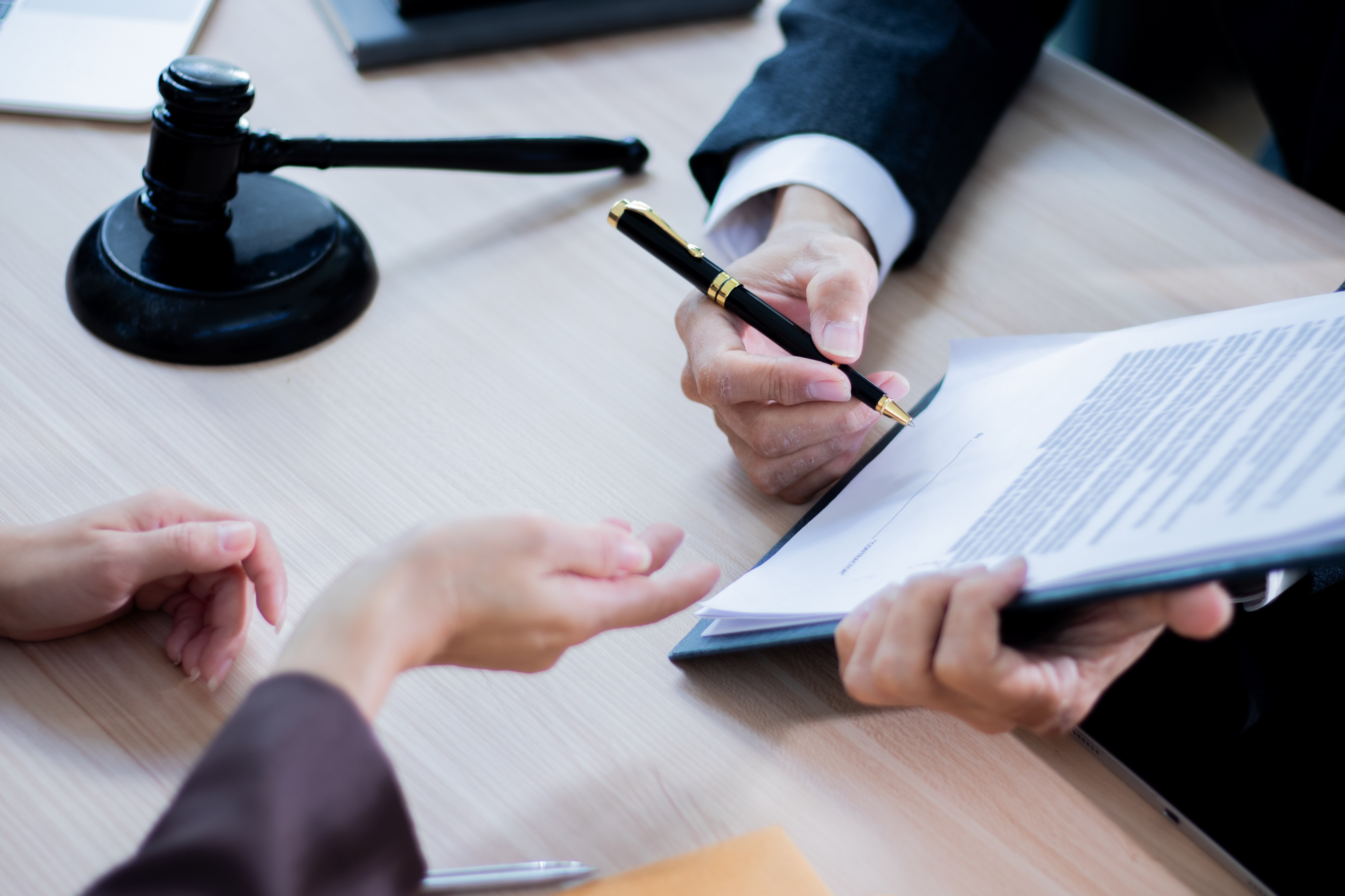 Solicitor handing a document to their client.