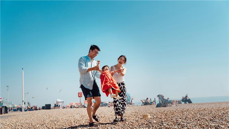 Family walking together at the beach 