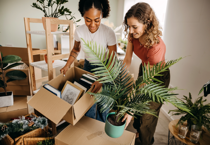 two women unpacking boxes in a house