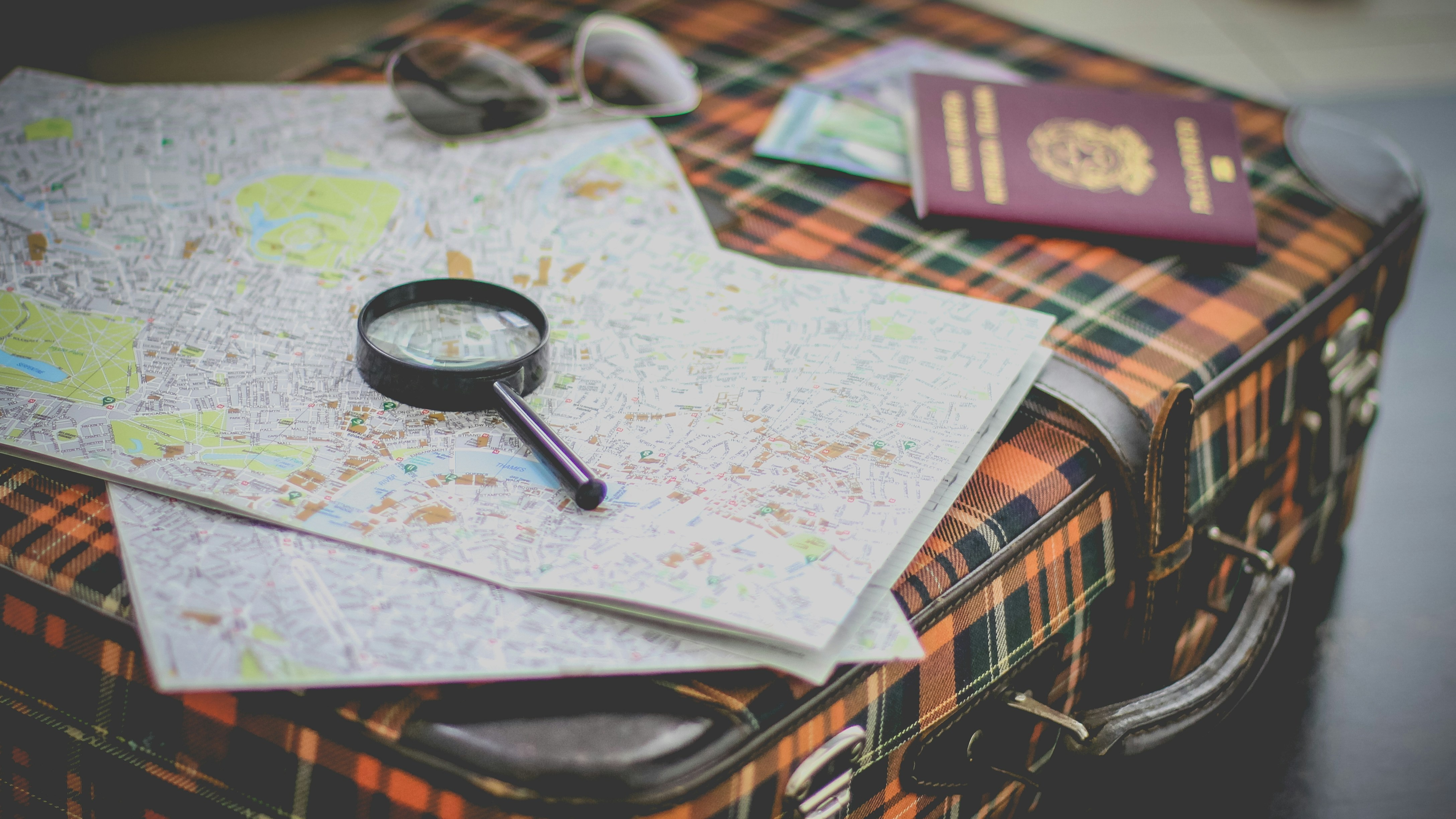 Suitcase with map and passport on top