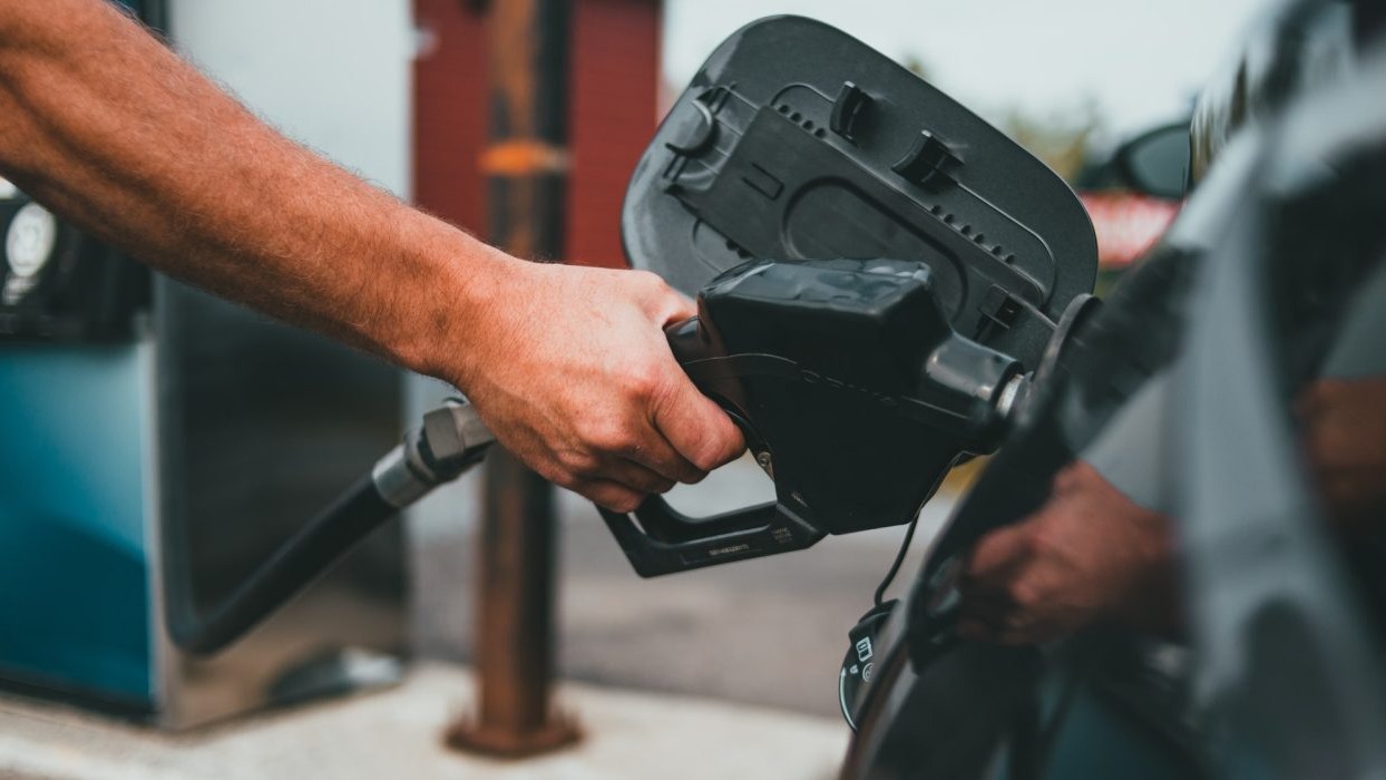 Person filling up car with fuel