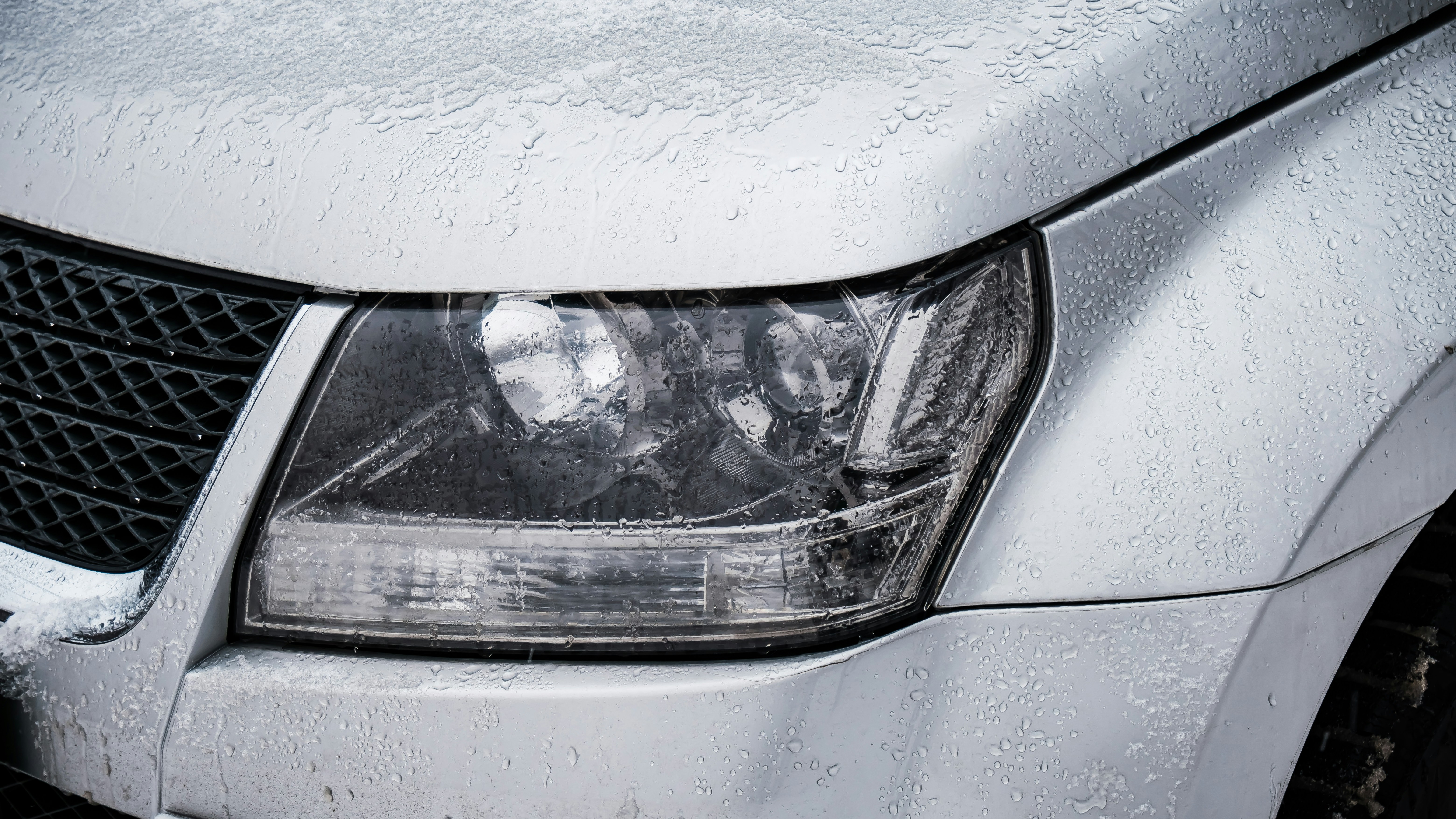 Car with ice and water on bonnet