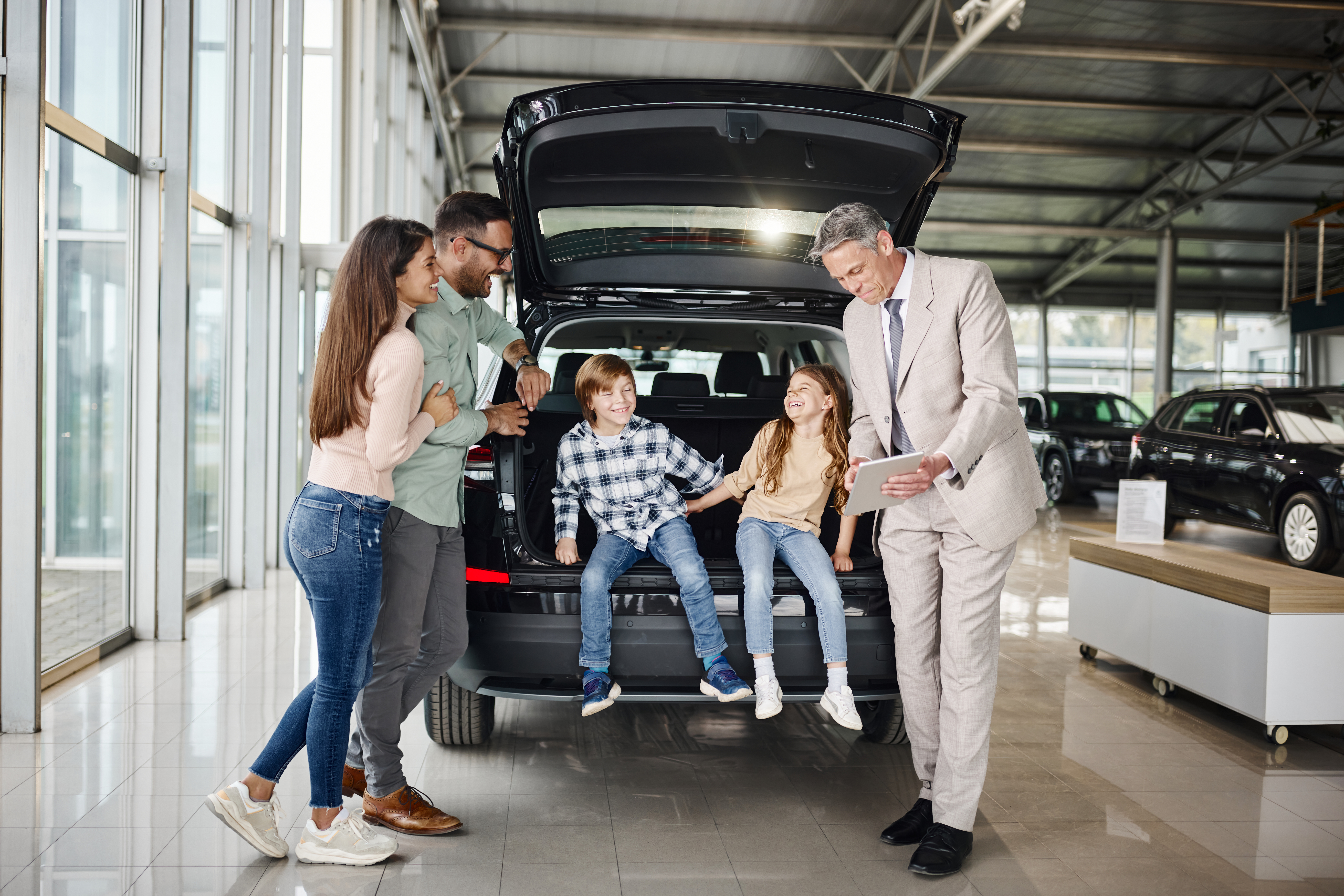 Family in a car showroom buying a car