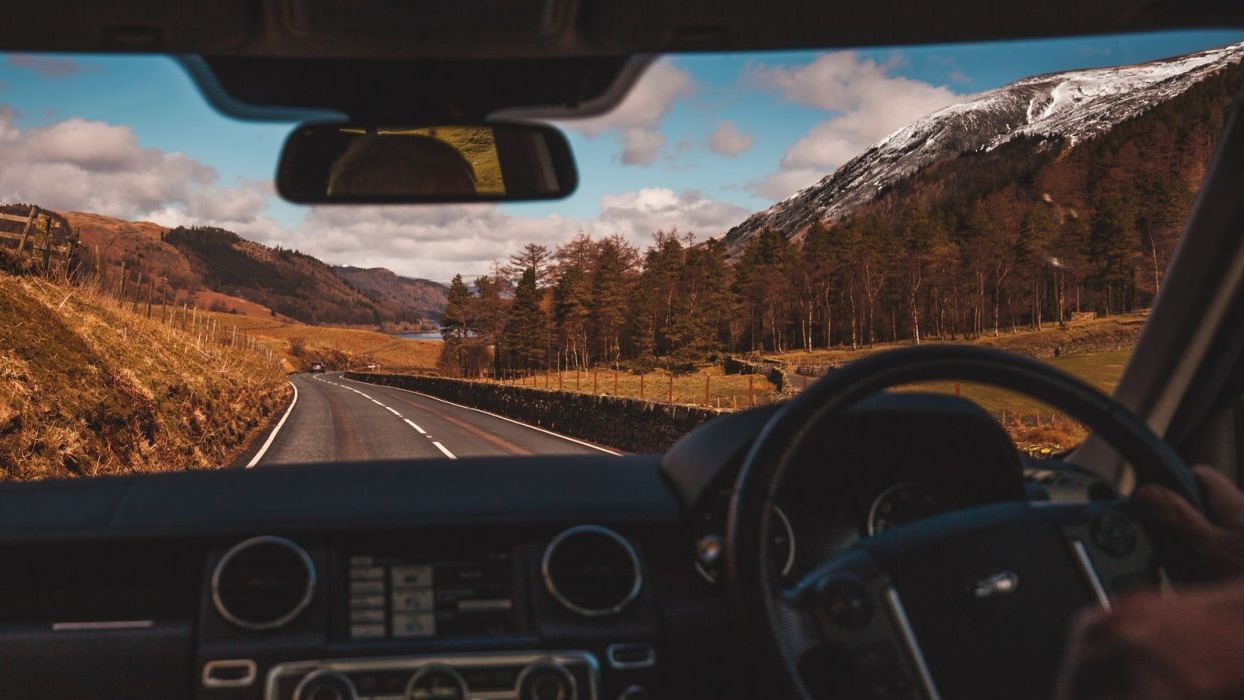 Car driving down country lane
