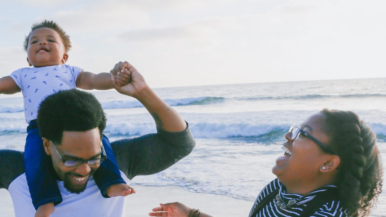 Family laughing at the beach