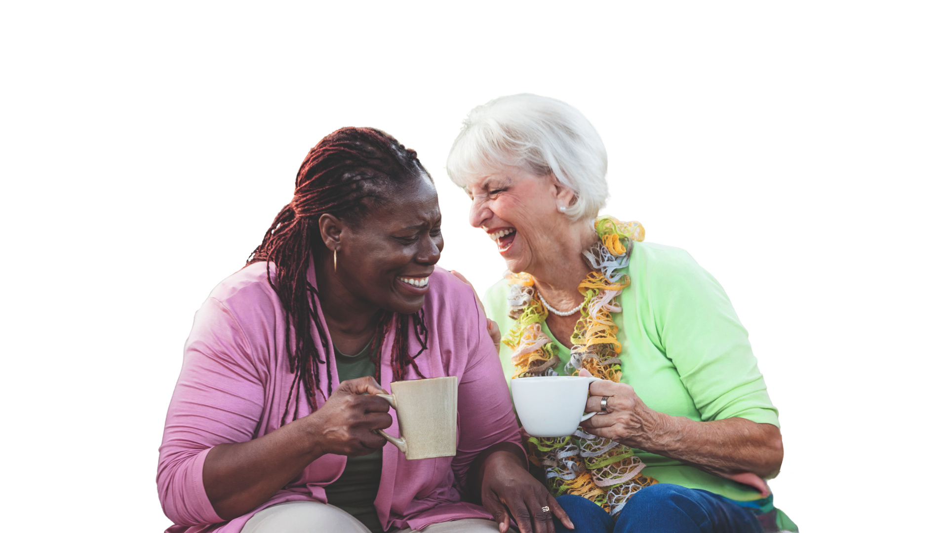 Two women laughing and drinking a cup of tea