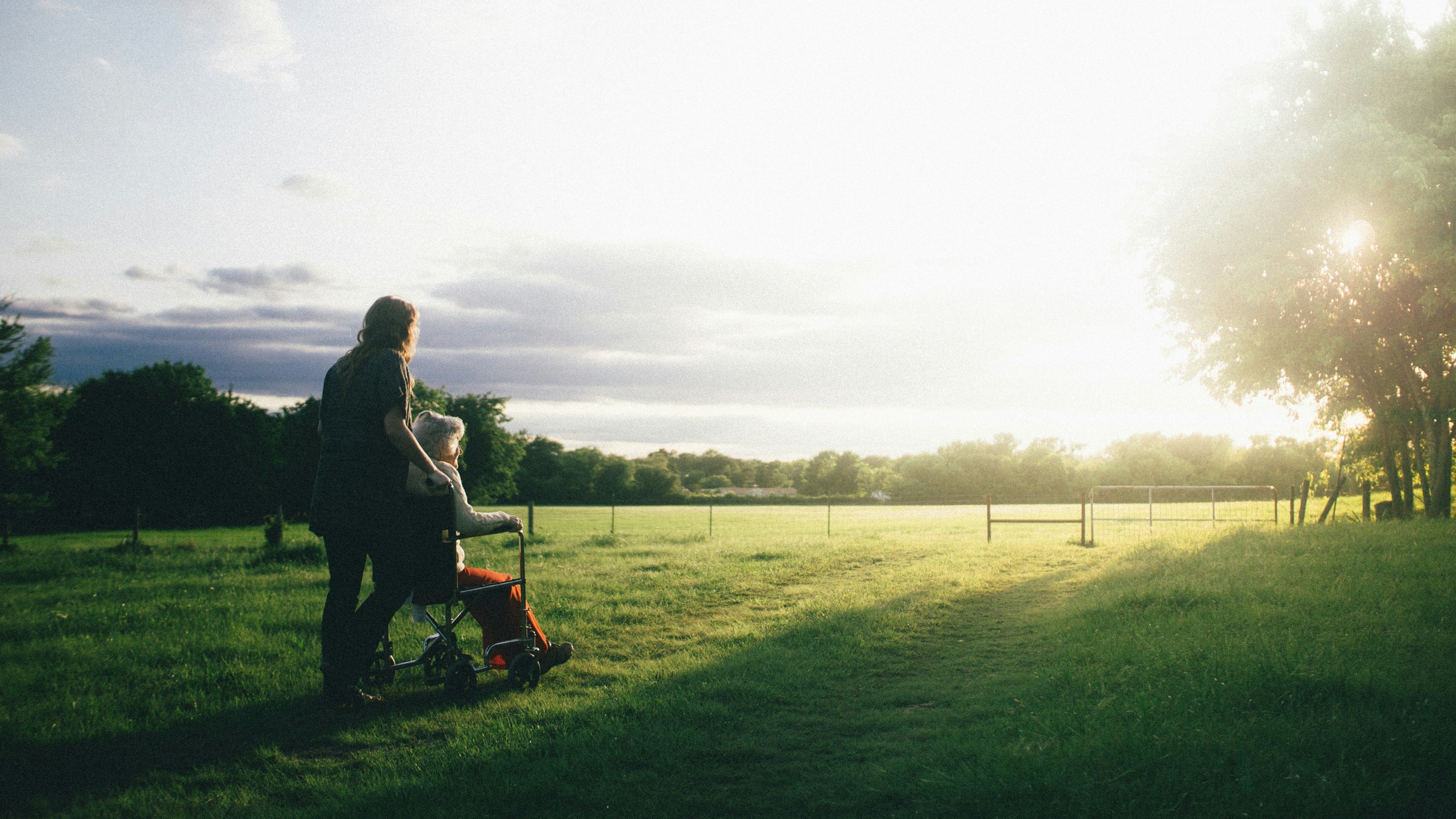 Person pushing someone in a wheelchair