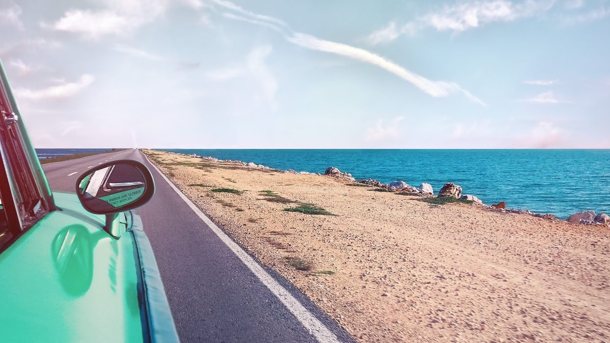 A car driving along a coastal road