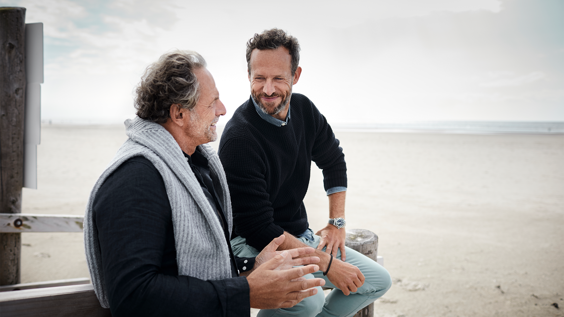 Father and son talking on a beach