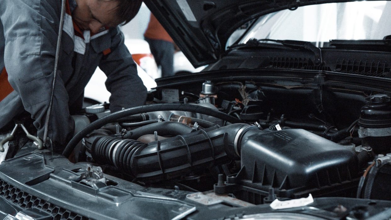 Mechanic looking under a car bonnet
